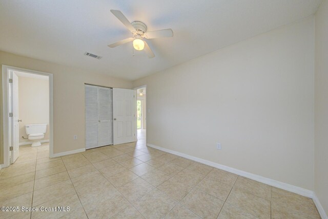 663 Bacon St, Cocoa, FL 32926 - unfurnished bedroom with light tile patterned floors, baseboards, a closet, and ensuite bathroom