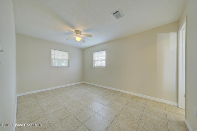 663 Bacon St, Cocoa, FL 32926 - empty room with ceiling fan, light tile patterned floors, and baseboards