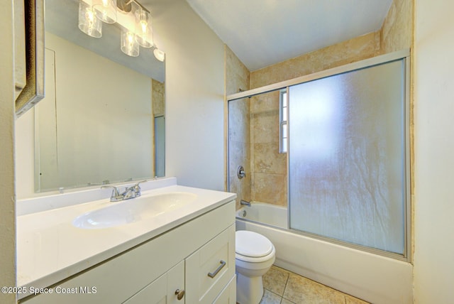 663 Bacon St, Cocoa, FL 32926 - bathroom with toilet, vanity, tile patterned flooring, and bath / shower combo with glass door