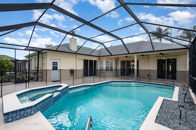 view of swimming pool featuring a ceiling fan, a patio area, a lanai, and a pool with connected hot tub