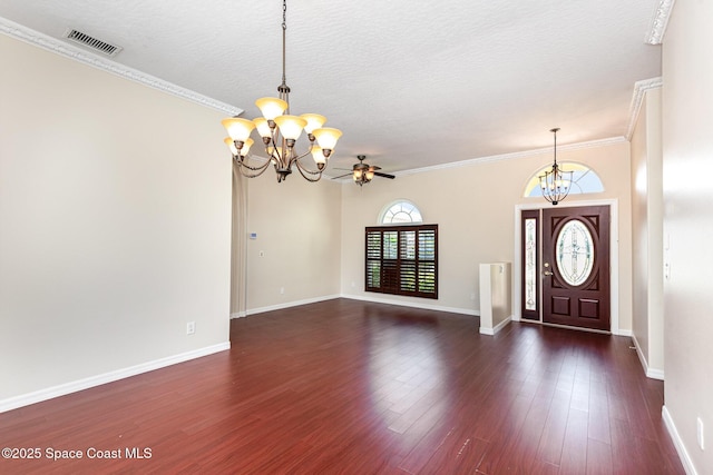 entrance foyer featuring a chandelier, baseboards, dark wood-style floors, crown molding, and a textured ceiling