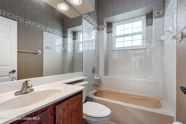 bathroom featuring bathtub / shower combination, toilet, and vanity