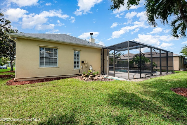rear view of property featuring stucco siding, a yard, an outdoor pool, and a patio