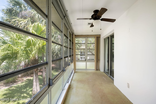 44 Vista Gardens Trl Unit 206, Vero Beach, FL 32962 - unfurnished sunroom featuring carpet flooring
