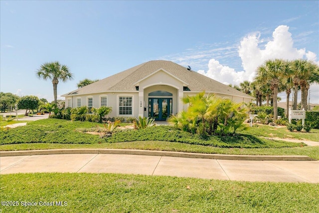 ranch-style house with french doors and stucco siding