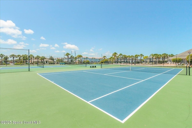 view of tennis court with fence and community basketball court