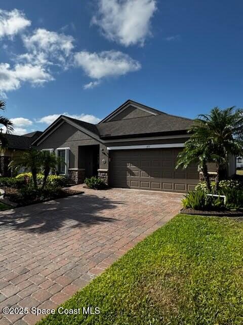 451 Dillard Dr SE, Palm Bay, FL 32909 - view of front of property with decorative driveway, an attached garage, and stucco siding