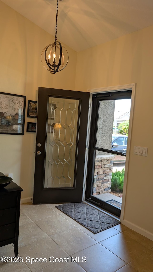 451 Dillard Dr SE, Palm Bay, FL 32909 - tiled foyer entrance featuring a chandelier and baseboards