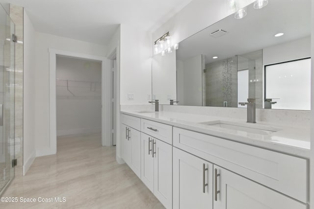 6002 Myrtle Dr, Ft Pierce, FL 34982 - full bathroom featuring a shower stall, a walk in closet, double vanity, baseboards, and recessed lighting