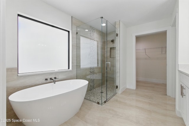 6002 Myrtle Dr, Ft Pierce, FL 34982 - full bathroom with a shower stall, a spacious closet, a freestanding bath, and vanity