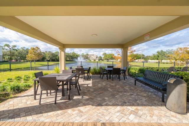 3848 Lexmark Ln Unit 307, Rockledge, FL 32955 - view of patio / terrace with outdoor dining area, a water view, and a fenced backyard