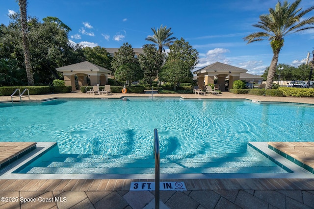 3848 Lexmark Ln Unit 307, Rockledge, FL 32955 - community pool featuring a patio area and fence