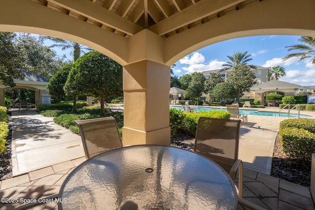 3848 Lexmark Ln Unit 307, Rockledge, FL 32955 - view of patio / terrace with outdoor dining area and a community pool
