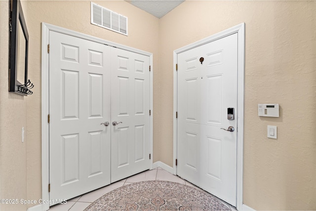3848 Lexmark Ln Unit 307, Rockledge, FL 32955 - entrance foyer featuring light tile patterned floors and a textured wall
