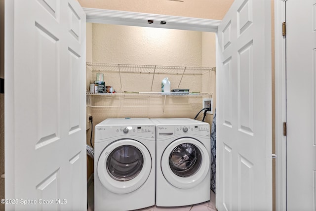 3848 Lexmark Ln Unit 307, Rockledge, FL 32955 - washroom with washing machine and dryer, a textured wall, and tile walls