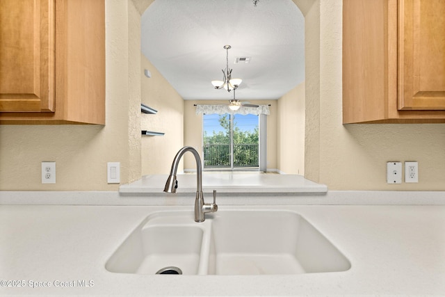 3848 Lexmark Ln Unit 307, Rockledge, FL 32955 - kitchen featuring a sink, light countertops, a textured wall, and a chandelier