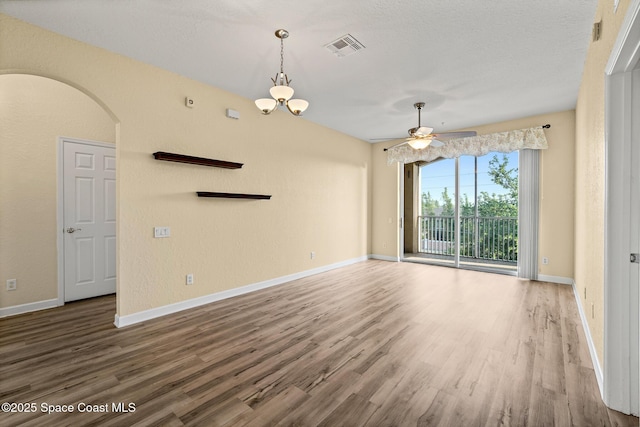 3848 Lexmark Ln Unit 307, Rockledge, FL 32955 - unfurnished living room with wood finished floors, ceiling fan, arched walkways, and baseboards