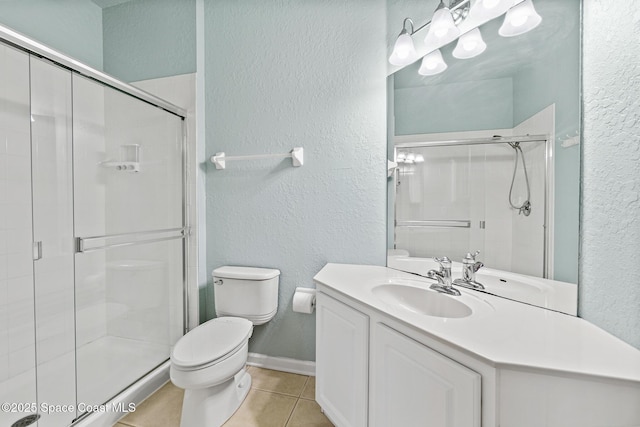 3848 Lexmark Ln Unit 307, Rockledge, FL 32955 - full bathroom with a textured wall, toilet, tile patterned flooring, a stall shower, and vanity