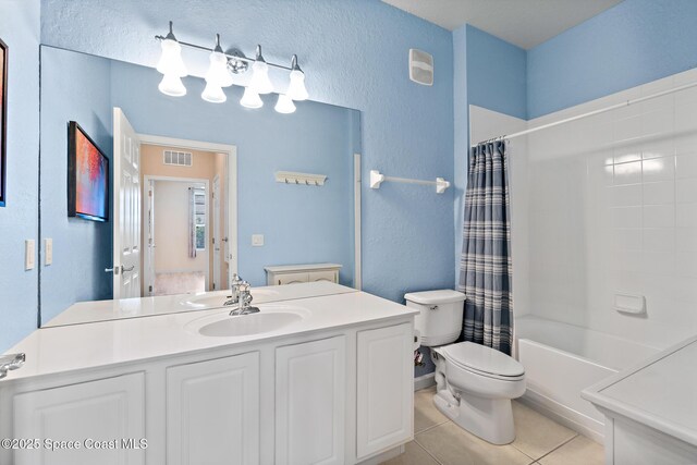 3848 Lexmark Ln Unit 307, Rockledge, FL 32955 - full bath featuring toilet, tile patterned flooring, a textured wall, vanity, and shower / tub combo