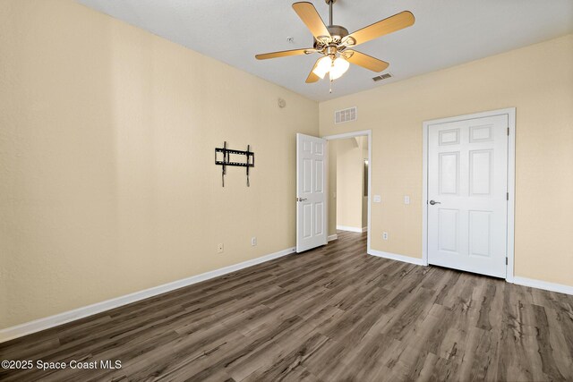 3848 Lexmark Ln Unit 307, Rockledge, FL 32955 - unfurnished bedroom with wood finished floors, baseboards, and a ceiling fan