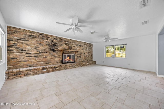 1303 Oxford Way, Cocoa, FL 32922 - unfurnished living room featuring ceiling fan, a brick fireplace, a textured ceiling, brick wall, and baseboards