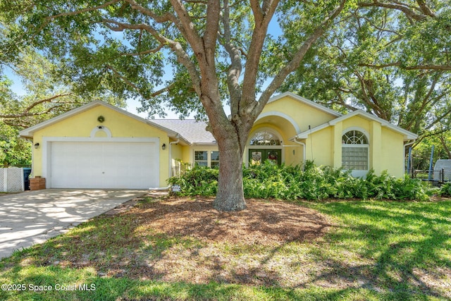 722 Hyannie St NE, Palm Bay, FL 32907 - single story home with an attached garage, stucco siding, and driveway