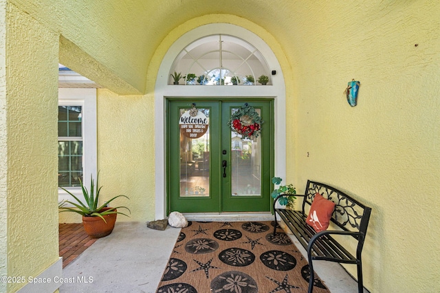 722 Hyannie St NE, Palm Bay, FL 32907 - property entrance with french doors and stucco siding