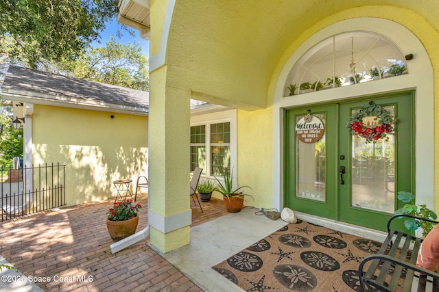 722 Hyannie St NE, Palm Bay, FL 32907 - view of exterior entry featuring stucco siding and french doors