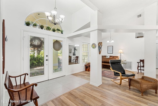 722 Hyannie St NE, Palm Bay, FL 32907 - entrance foyer featuring a chandelier, high vaulted ceiling, and light wood-type flooring