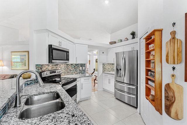 722 Hyannie St NE, Palm Bay, FL 32907 - kitchen featuring stainless steel appliances, a sink, decorative backsplash, and white cabinets