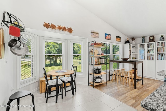 722 Hyannie St NE, Palm Bay, FL 32907 - dining room featuring lofted ceiling, light tile patterned floors, and baseboards