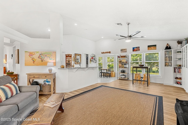 722 Hyannie St NE, Palm Bay, FL 32907 - living area featuring a ceiling fan, light wood finished floors, vaulted ceiling, baseboards, and recessed lighting