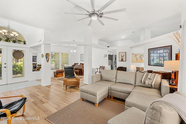 722 Hyannie St NE, Palm Bay, FL 32907 - living room featuring a chandelier, high vaulted ceiling, light wood-style flooring, a ceiling fan, and french doors