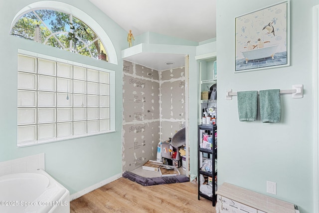 722 Hyannie St NE, Palm Bay, FL 32907 - full bath with wood finished floors, a garden tub, and a shower