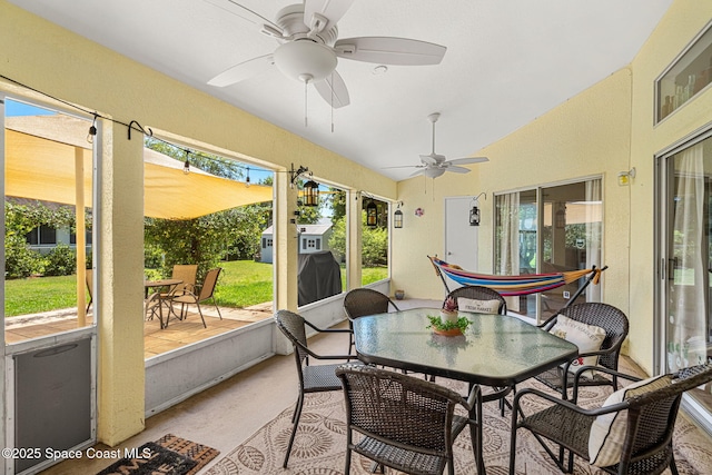 722 Hyannie St NE, Palm Bay, FL 32907 - sunroom featuring outdoor dining area, lofted ceiling, a ceiling fan, and plenty of natural light