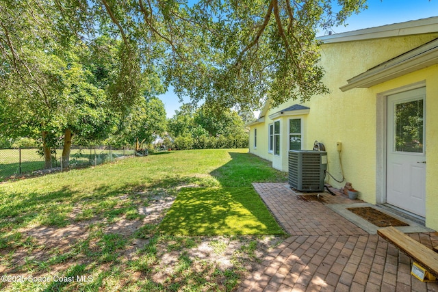 722 Hyannie St NE, Palm Bay, FL 32907 - view of yard with cooling unit and a patio area