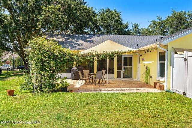 722 Hyannie St NE, Palm Bay, FL 32907 - back of house featuring a patio area and a shingled roof