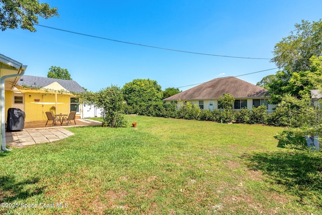 722 Hyannie St NE, Palm Bay, FL 32907 - view of grassy yard featuring a patio area