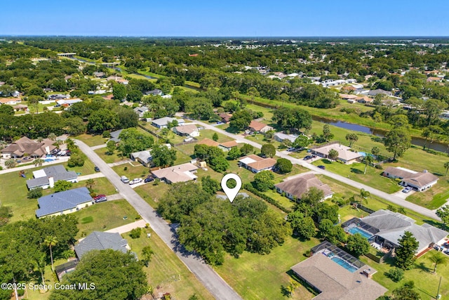 722 Hyannie St NE, Palm Bay, FL 32907 - aerial view of property and surrounding area with nearby suburban area and a large body of water