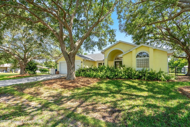 722 Hyannie St NE, Palm Bay, FL 32907 - ranch-style home with a front yard, an attached garage, concrete driveway, and stucco siding