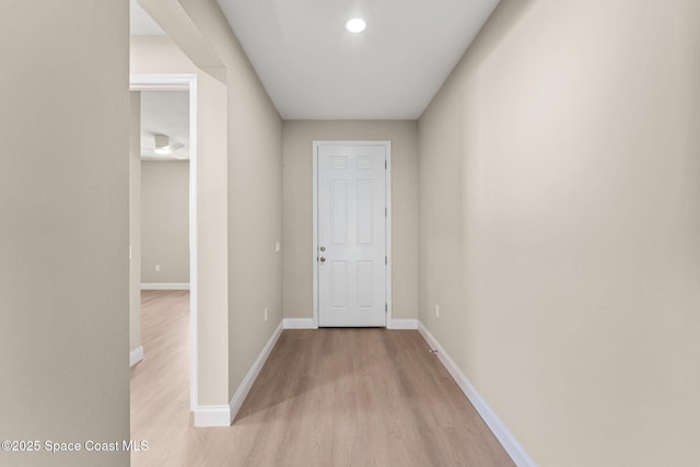 563 Holmes Ave NW, Palm Bay, FL 32907 - hallway featuring light wood finished floors, baseboards, and recessed lighting