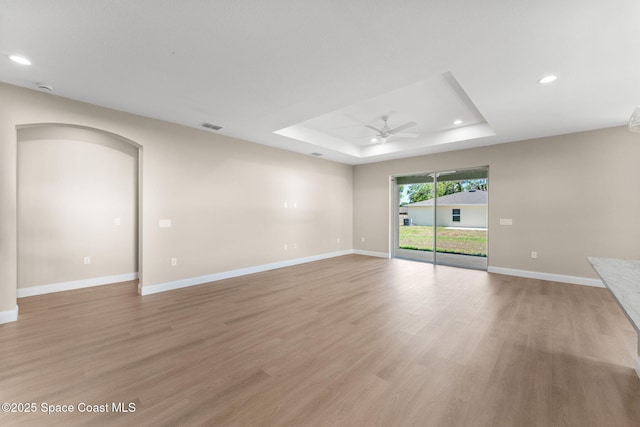 563 Holmes Ave NW, Palm Bay, FL 32907 - spare room with a raised ceiling, ceiling fan, light wood-type flooring, recessed lighting, and baseboards