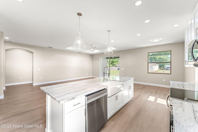 563 Holmes Ave NW, Palm Bay, FL 32907 - kitchen with dishwasher, a sink, light wood-type flooring, white cabinets, and recessed lighting