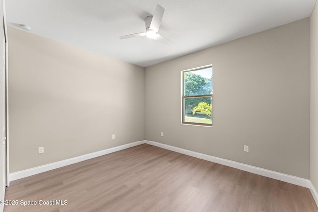 563 Holmes Ave NW, Palm Bay, FL 32907 - empty room featuring a ceiling fan, light wood-style floors, and baseboards