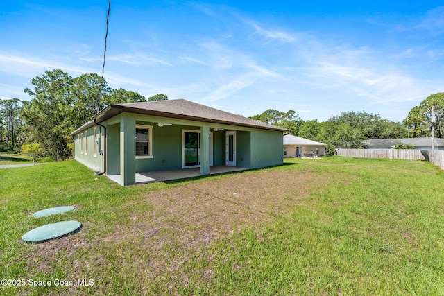 563 Holmes Ave NW, Palm Bay, FL 32907 - back of house with a patio area, stucco siding, and a ceiling fan