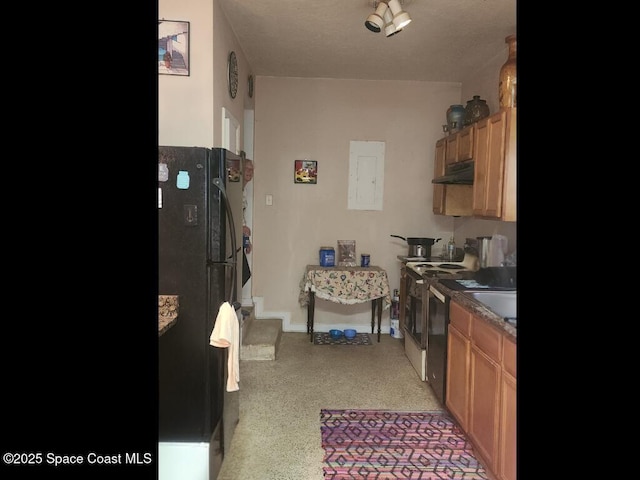 kitchen with under cabinet range hood, freestanding refrigerator, electric stove, and baseboards