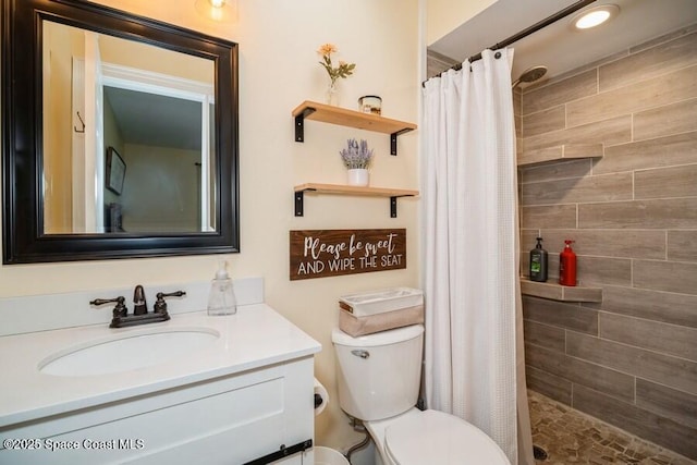 2160 Emerald Ct, Merritt Island, FL 32953 - full bathroom featuring a tile shower, toilet, and vanity