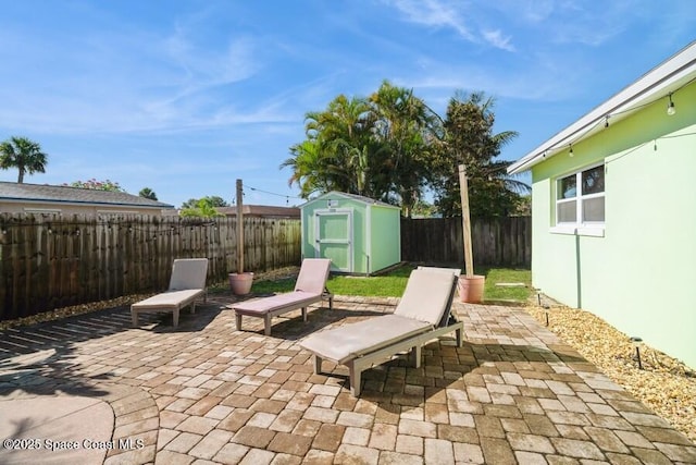 2160 Emerald Ct, Merritt Island, FL 32953 - view of patio / terrace with a storage shed, a fenced backyard, and an outbuilding