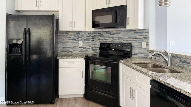 544 Plumbago Rd NW, Palm Bay, FL 32907 - kitchen with black appliances, a sink, and white cabinetry