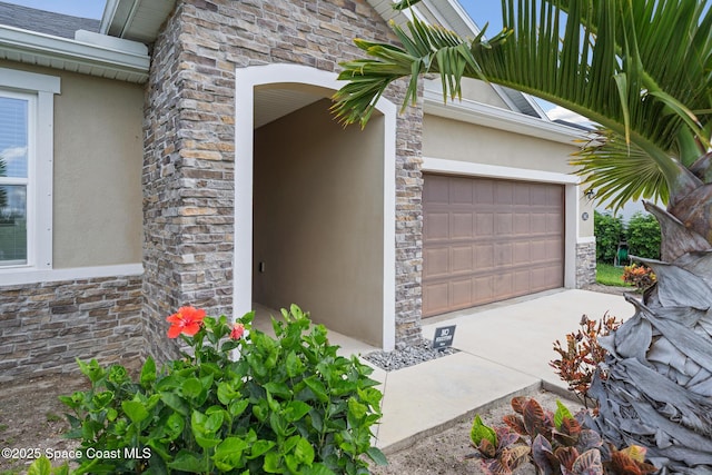 1662 Orsi Pl, West Melbourne, FL 32904 - doorway to property with stone siding, stucco siding, and a garage